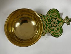 Brass ladle in gilt with green enamel